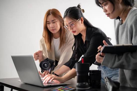 two girls focused on their laptops
